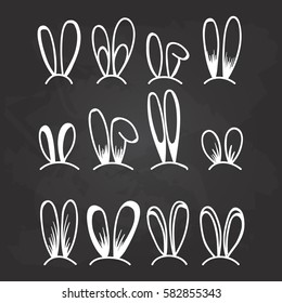 Rabbit and bunny ears set for Easter decoration on the black chalkboard background