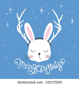 Rabbit with deer horns. Christmas card. Cute bunny and lettering
