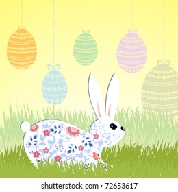 Rabbit with Easter eggs on lawn