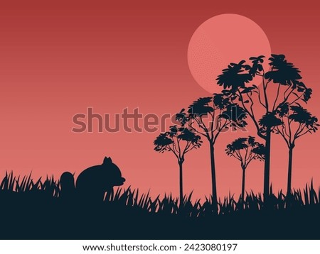 Rabbit eating grass at sunset time on silhouette background 