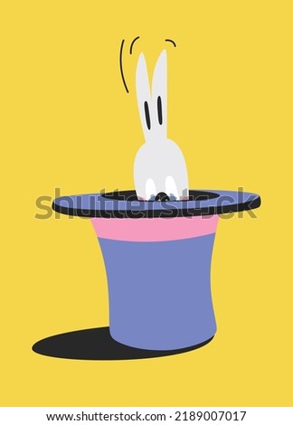 The rabbit hid in a hat and looks out from there. Focus on the disappearance and appearance of a rabbit in a hat. New Year's talisman 2023. The hare trembles in fear, moving its ears.