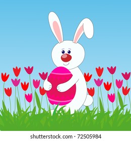 rabbit holding easter egg  on the lawn