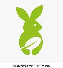 Rabbit Leaf Logo Negative Space Concept Vector Template. Rabbit Holding Leaf Symbol