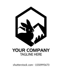 Rabbit silhouette logo with mountain in the hexagon, flat design. Vector Illustration on white background