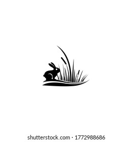 rabbit sitting in green grass. vector illustration in flat design.

