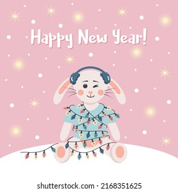 Сute rabbit in winter headphones is wrapped in a garland. Winter card with shining lights and snow. Happy New Year text. Vector illustration