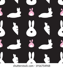 Rabbits and carrots seamless pattern on a black background. Black, white, and pink vector illustration.