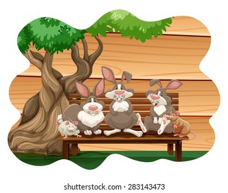 Rabbits and mice sitting on a bench under a tree