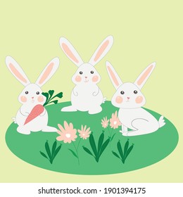 Rabbits on a green grass with carrot