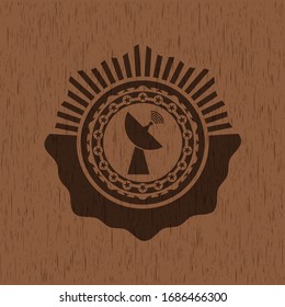 radar icon inside badge with wood background