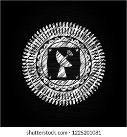 radar icon inside chalkboard emblem on black board