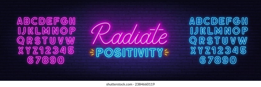 Radiate Positivity neon lettering on brick wall background.