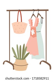 Rail with a summer wardrobe. Bright dresses, a hat and a straw bag. Shopping. Decor in the room. Summer mood. Spring fashion - pastel colored clothes on rail. Sale at clothing store concept.