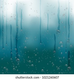 Rain water drops flow down on dark blue background. Beautiful fresh aqua bubble shape natural droplets backdrop. Rain bubbles template on a surface