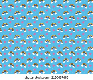 Rainbow with clouds and a pink lollipop in the shape of a heart.
Candy lollipops with rainbows seamless pattern illustration on blue background for textile, postcard, wallpaper design.