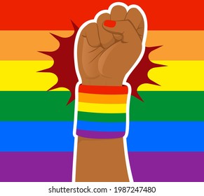 Rainbow colored LGBT flag background with black woman fist raised up wearing wristband