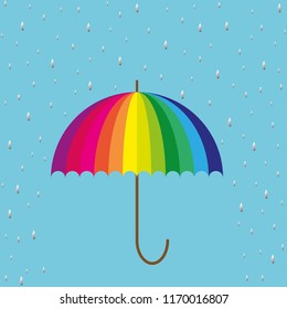rainbow colored umbrella on blue background with raindrops
