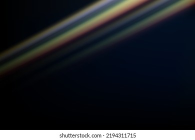 Rainbow highlights on a black background.Glare or reflection from water and glass.Glittering  particles for social media backgrounds, product presentations, photo shots.