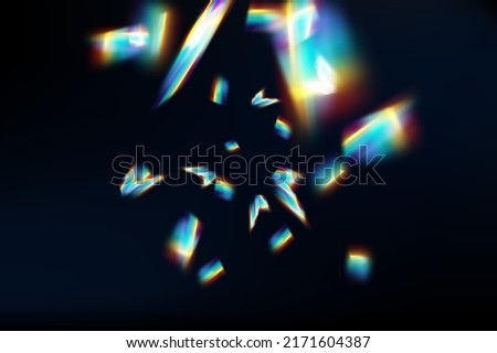 Rainbow highlights on a black background.Glare or reflection from water and glass.Glittering  particles for social media backgrounds, product presentations, photo shots.