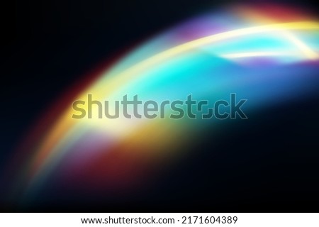 Rainbow highlights on a black background.Glare or reflection from water and glass.Glittering  particles for social media backgrounds, product presentations, photo shots.