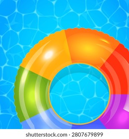 Rainbow inflatable ring floats in clear blue water. Bright colors reflect sunlight with soft ripples. Swimming pool scene evokes summer fun and relaxation. Ideal for vacation, holiday