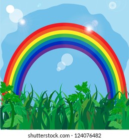 rainbow on to the meadow with a green grass on a background blue sky