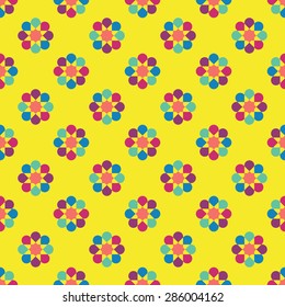 Rainbow seamless pattern of abstract flowers. Simple background. Round motif. 
