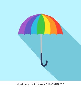 Rainbow umbrella with long shadow isolate on blue background.