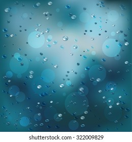 Rainy background with drops of rain on the glass