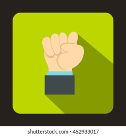 Raised up clenched male fist icon in flat style on a green background