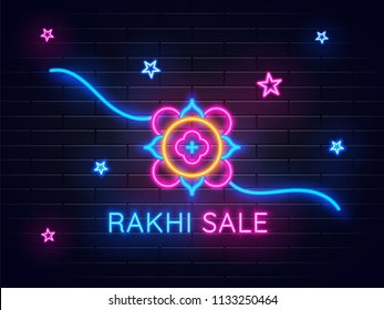 Rakhi Sale text with illustration of rakhi neon sign on brick wall background.