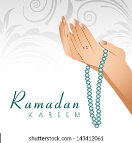 Ramadan Kareem background with female human hands holding rosary and praying(reading Namaz, Islamic Prayer) on floral decorated grey background.