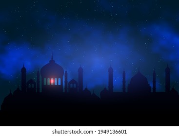 Ramadan Kareem background with mosque silhouette against night sky 