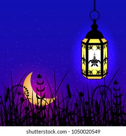 Ramadan Kareem. Concept of a Islamic holiday. Lantern hanging on a chain. The moon rises. Below grass. Background blue night sky