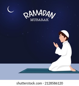 Ramadan Mubarak Concept With Side View Of Islamic Boy Offering Namaz (Prayer) At Mat On Blue Nighttime Background.