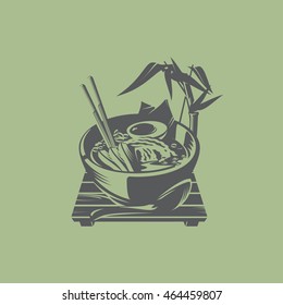 Ramen cup on a wooden stand and bamboo branch
