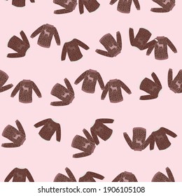 Random brown knitted sweaters ornament seamless pattern. Light pink background. Vector illustration for seasonal textile prints, fabric, banners, backdrops and wallpapers.