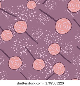 Random candy ornament silhouettes seamless pattern. Purple background with splashes. Pink lollipops. Perfect for wallpaper, textile, wrapping paper, fabric print. Vector illustration.
