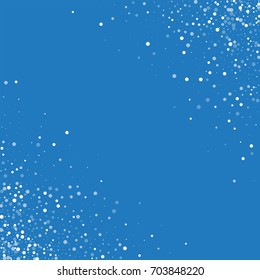 Random falling white dots. Scatter cornered border on blue background. Vector illustration.