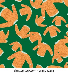 Random orange sweater knitted clothes seamless pattern. Green bright background. Vector illustration for seasonal textile prints, fabric, banners, backdrops and wallpapers.