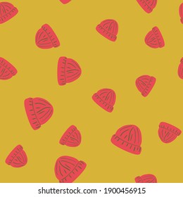 Random pink colored beanie hat seamless doodle pattern. Yellow background. Warm winter backdrop. Stock illustration. Vector design for textile, fabric, giftwrap, wallpapers.