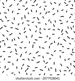 Random placed black strokes seamless repeat pattern. Short vector lines all over minimal print on white background.