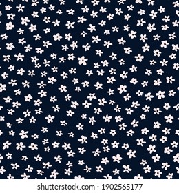 Random placed vector ditsy daisy cropped seamless pattern with dark blue background.