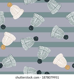 Random seamless Christmas pattern with cartoon wool hat shapes. Blue and purple striped background. Graphic design for wrapping paper and fabric textures. Vector Illustration.
