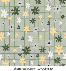 Random seamless naive pattern with chamomile abstract flowers. Floral ornament in orange and green colors on grey chequered background. Vector illustration.