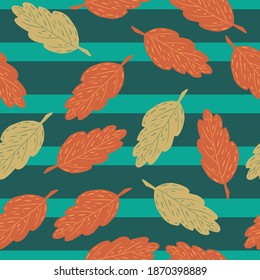 Random seamless pattern with orange and beige colored fall foliage. Blue striped background. Vector illustration for seasonal textile prints, fabric, banners, backdrops and wallpapers.