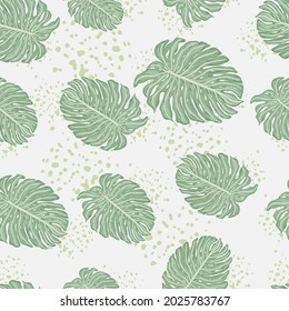 Random seamless pattern with pale green monstera leaf silhouettes. Grey background with splashes. Decorative backdrop for fabric design, textile print, wrapping, cover. Vector illustration.