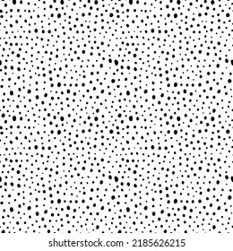 Random small specks vector seamless pattern. Trendy grunge design with dots, rough small circles. Black uneven specks, spots, blobs, splashes. Hand drawn dotted texture. Black ink splatter