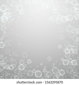 Random soap bubbles abstract background. Blowing bubbles on light grey background. Bold soapy foam overlay template. Tempting vector illustration.