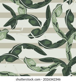 Random tropical leaves silhouettes seamless floral pattern. Pastel striped background. Simple style. Vector illustration for seasonal textile prints, fabric, banners, backdrops and wallpapers.